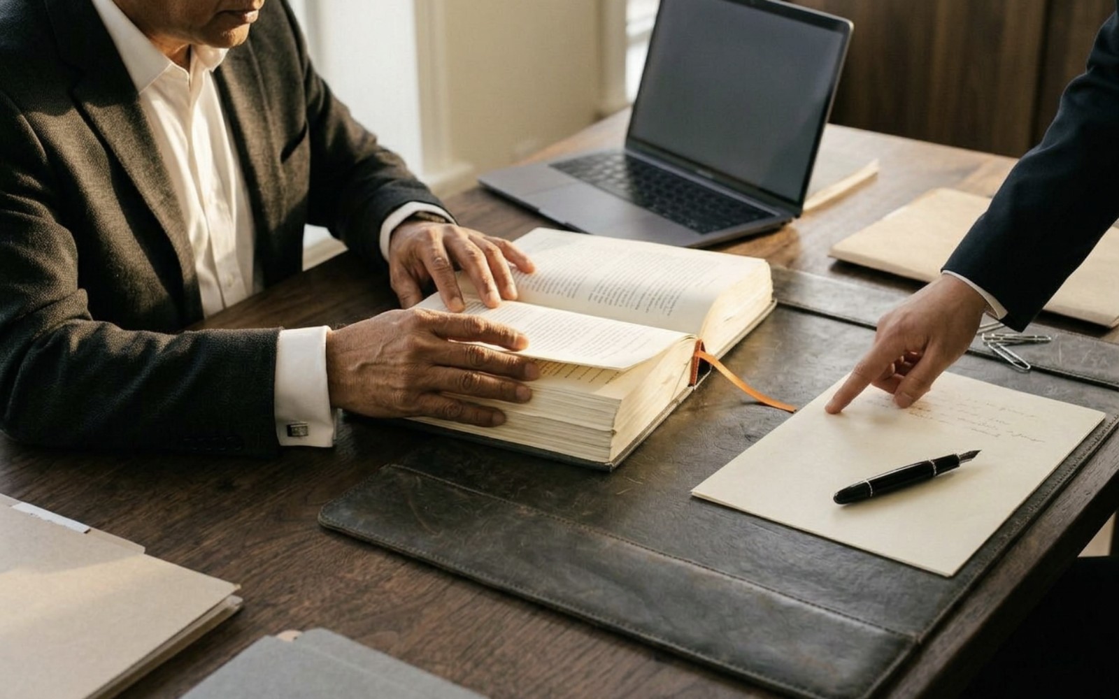 Legal staff working with laptops and case files
